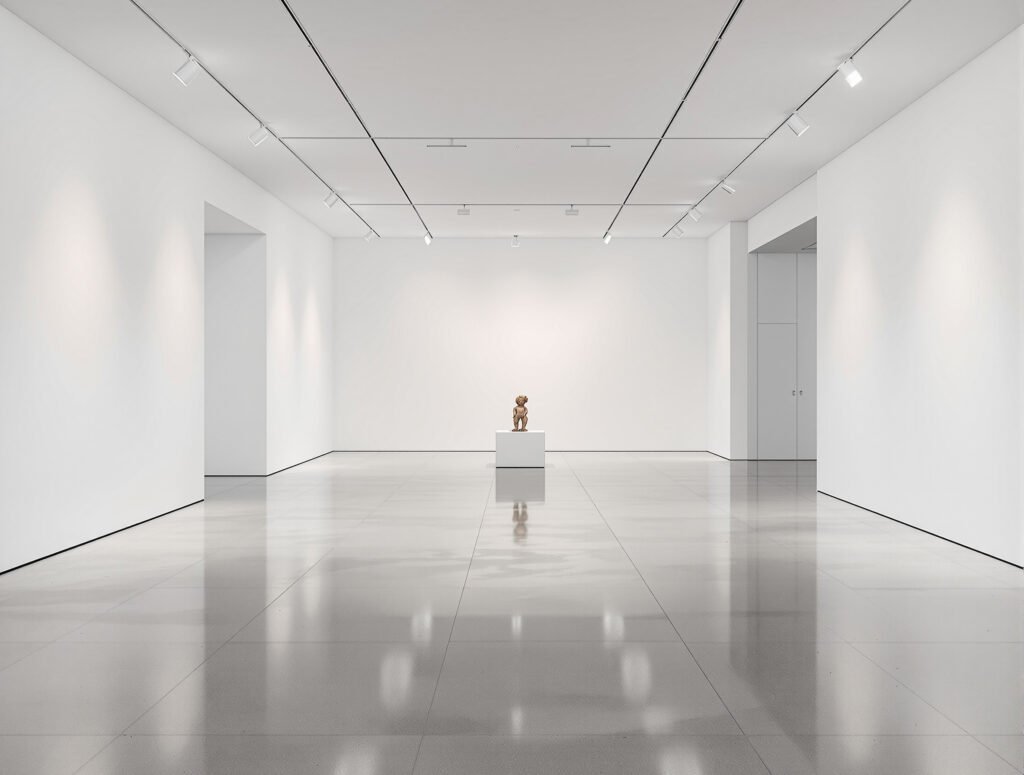 A white-walled gallery with a single sculpture — museum architecture as the art of getting out of the art's way.
