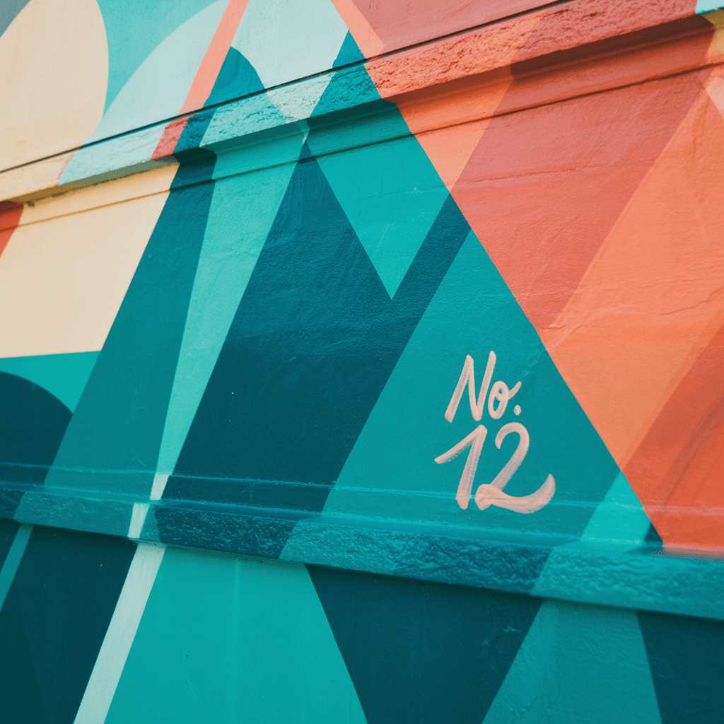 A close-up of a bold three-color geometric mural — large-scale graphic design applied to real architecture.