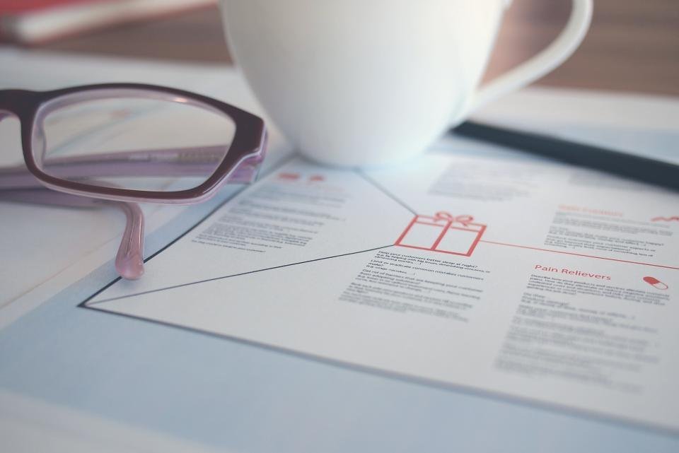 Glasses and a coffee cup on a printed document