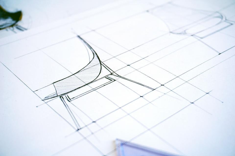 Pencil sketch of a chair on a drafting grid