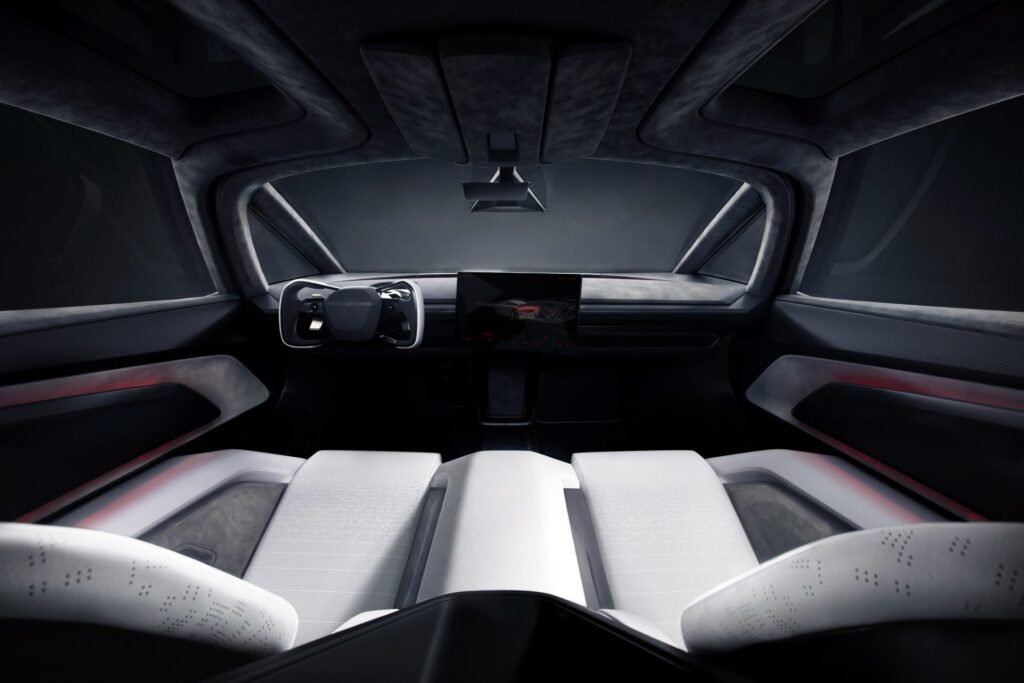 Inside the 2026 Tesla Roadster: minimalist cockpit with yoke steering wheel, central touchscreen and two white sports seats