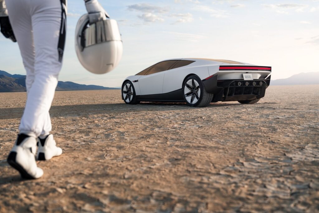 2026 Tesla Roadster rear view with full-width red light bar and rear thrusters, photographed in the desert